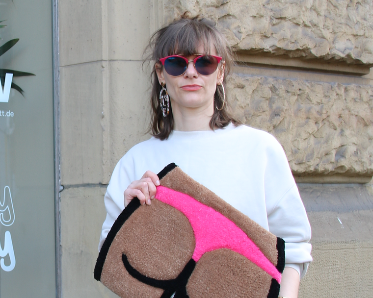 woman holding booty tufted rug