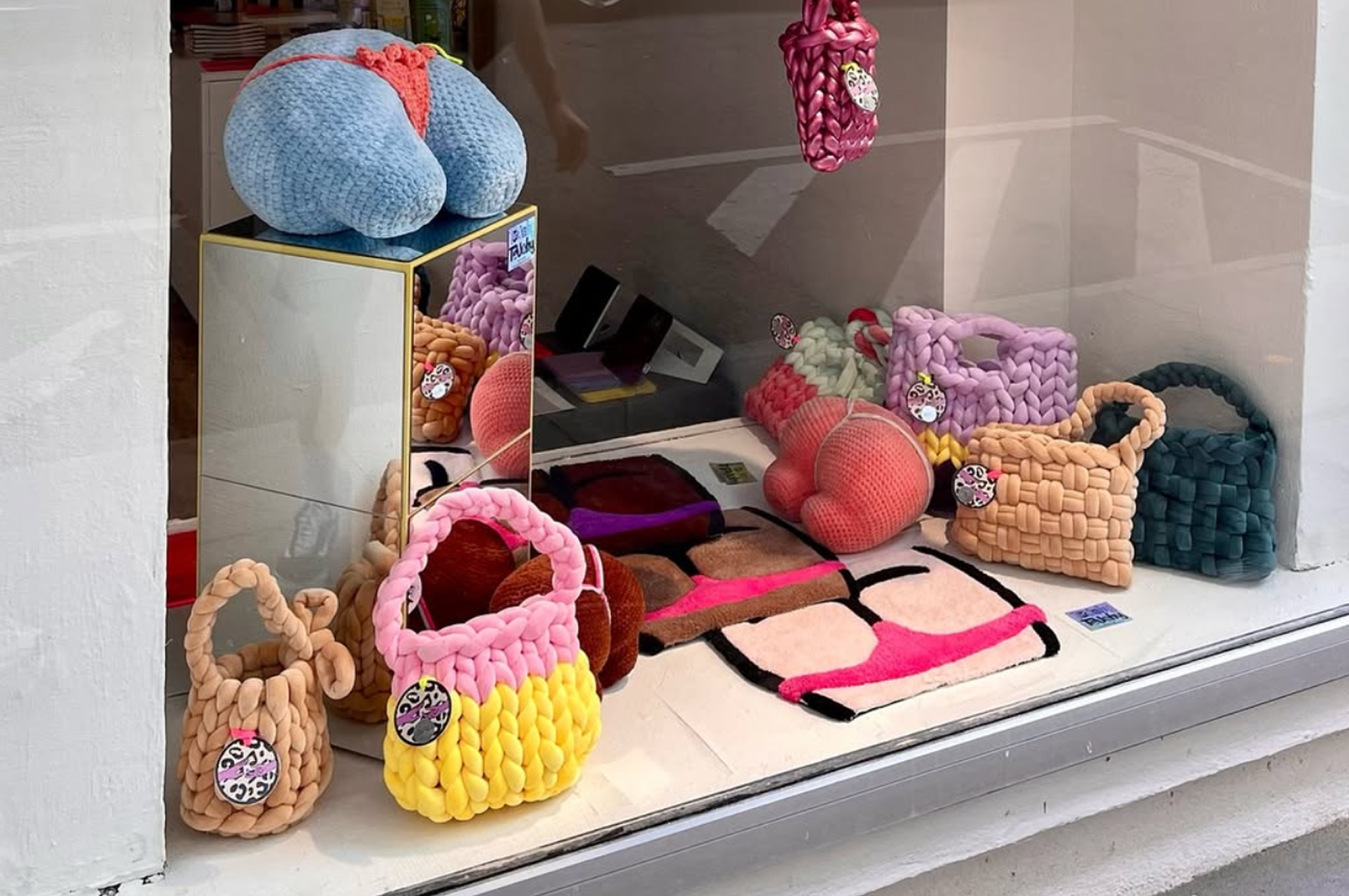 a store display crochet bags, booty pillows and hand tufted booty rugs
